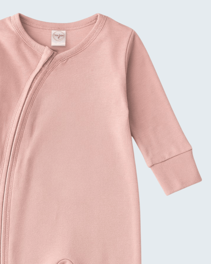 Soft coral cotton romper with zip-front neckline and long sleeves, cuffed hems