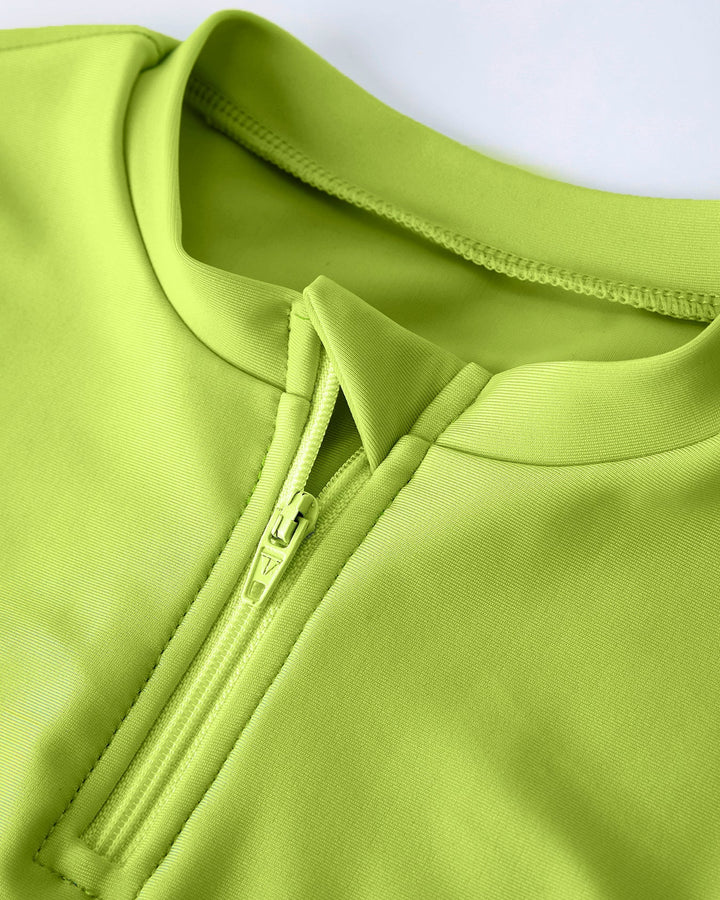 Close-up of a green swim top with a zipper on a white background