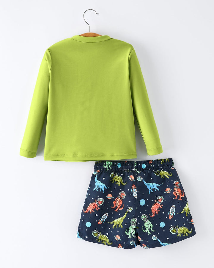 Green long-sleeve shirt and navy shorts with dinosaur pattern on a white background
