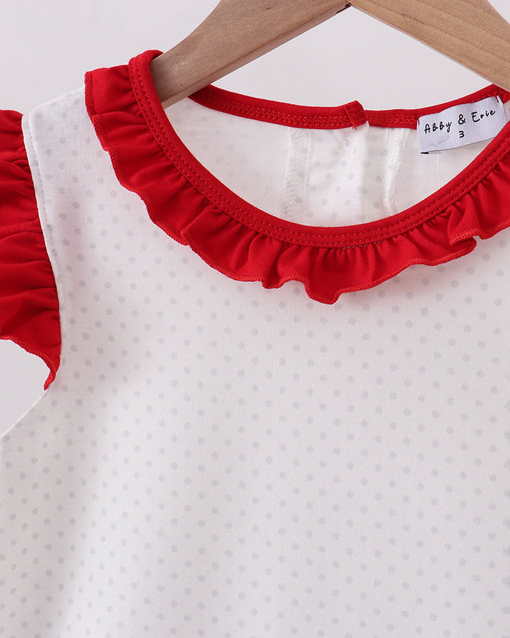 White dress with red ruffled collar on a hanger