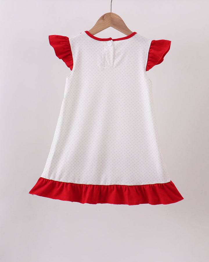 White dress with red trim on a hanger against a white background