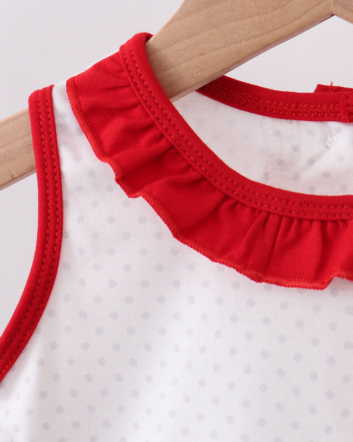 White sleeveless top with red ruffled collar on a hanger