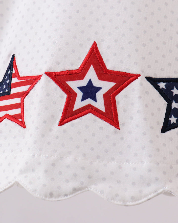 Close-up of a white fabric with red, white, and blue star designs.