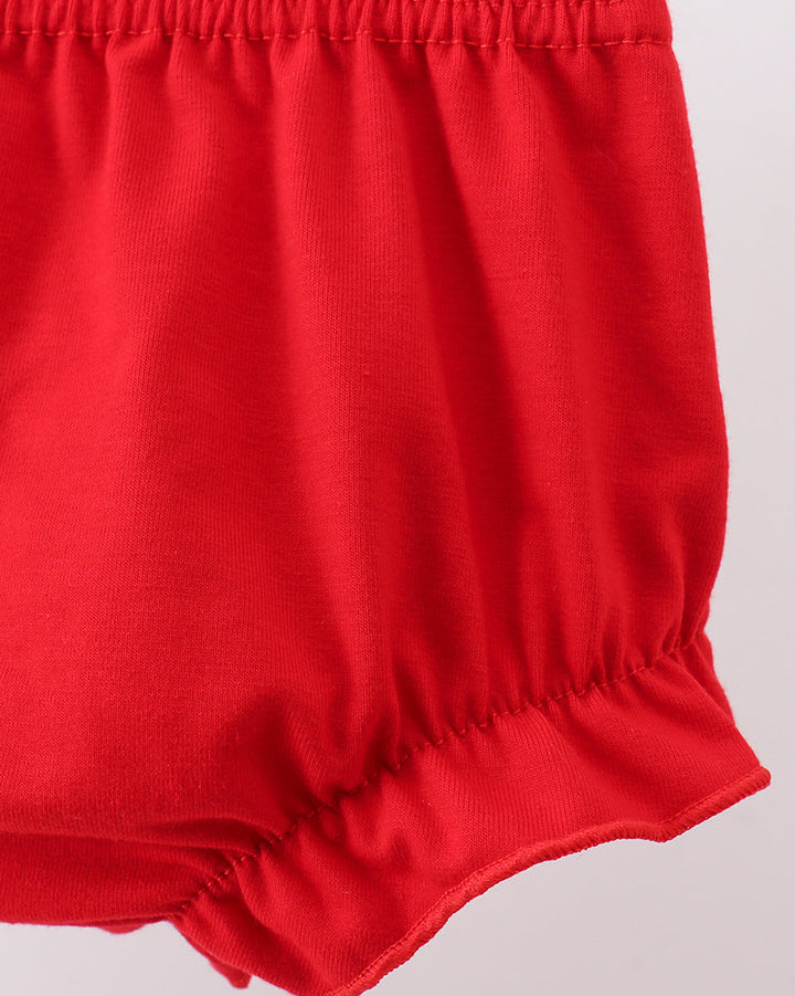 Red baby bloomers on a light gray background