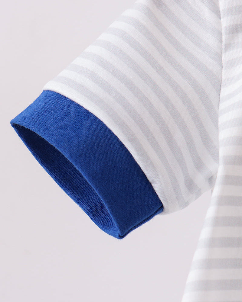 Close-up of a white shirt with blue cuffs on a light gray background