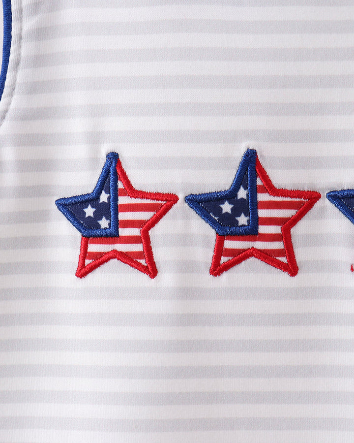 Close-up of a white shirt with red and blue star designs.