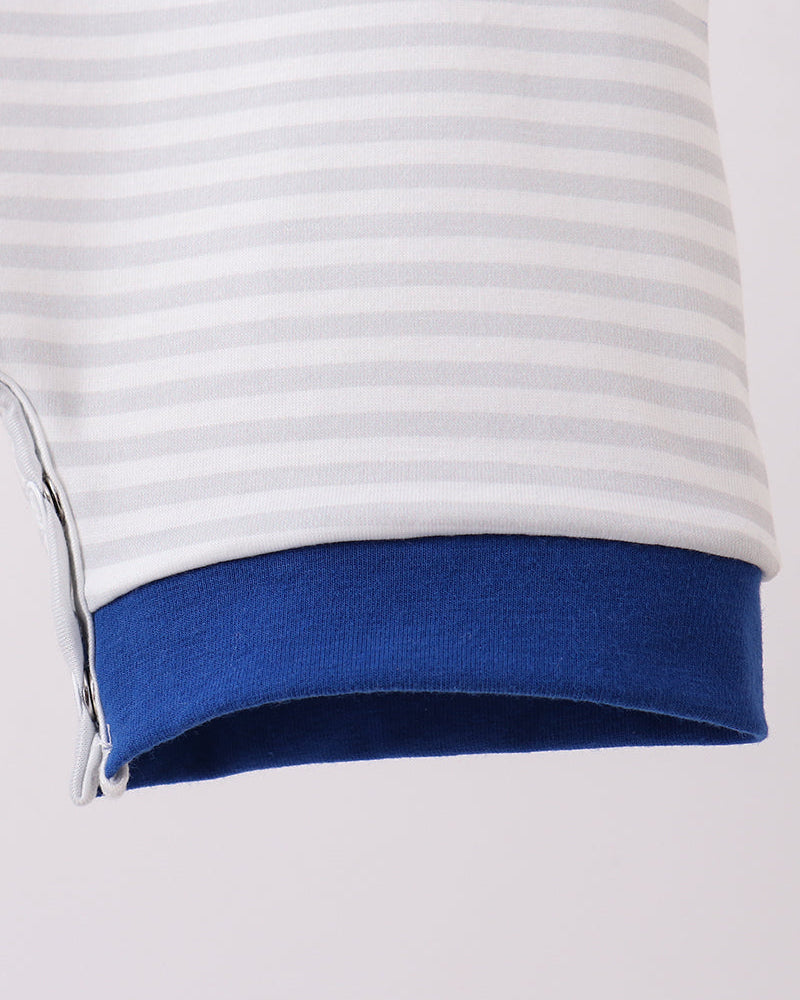 Close-up of a white and blue striped shirt with a zipper on a light gray background