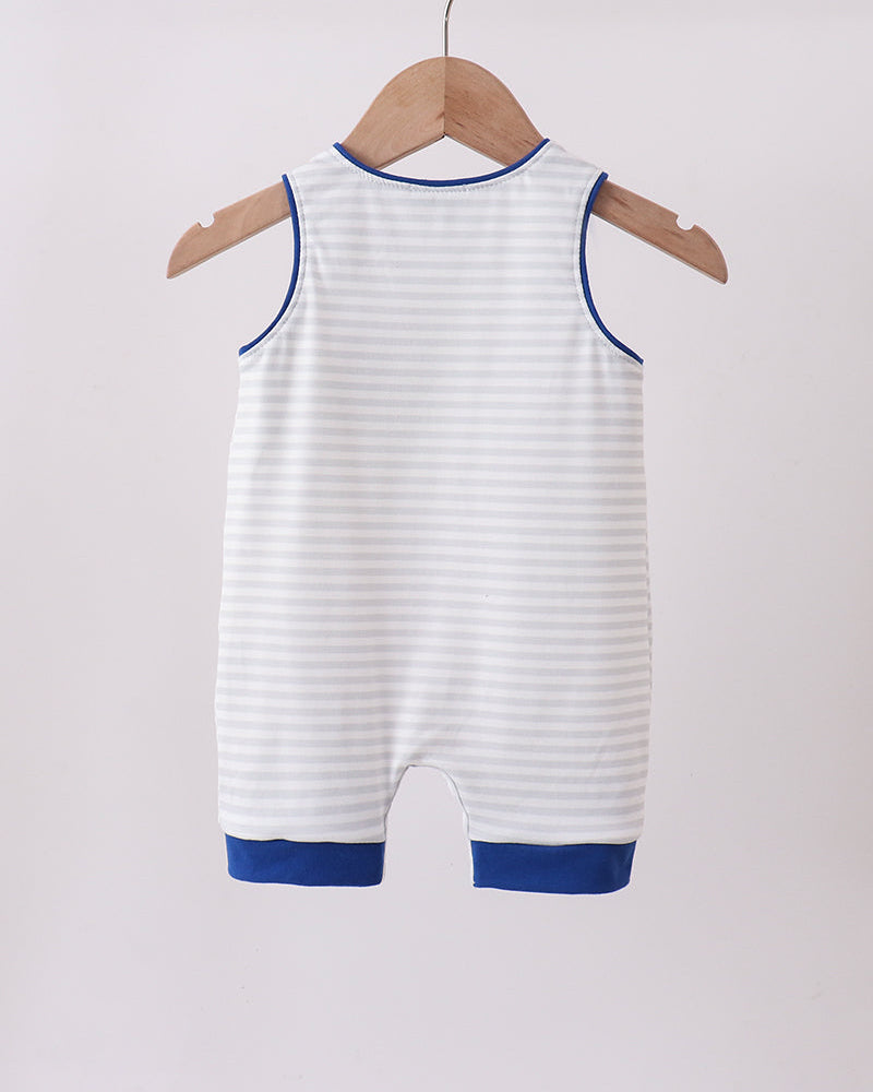 White baby romper with blue trim hanging on a wooden hanger against a white background