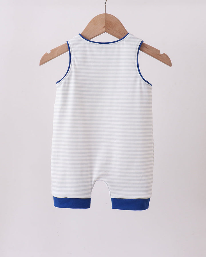 White baby romper with blue trim hanging on a wooden hanger against a white background