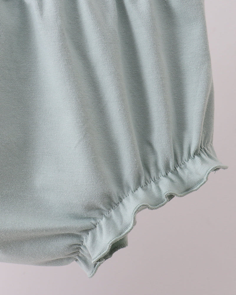 Light blue baby bloomers on a light pink background
