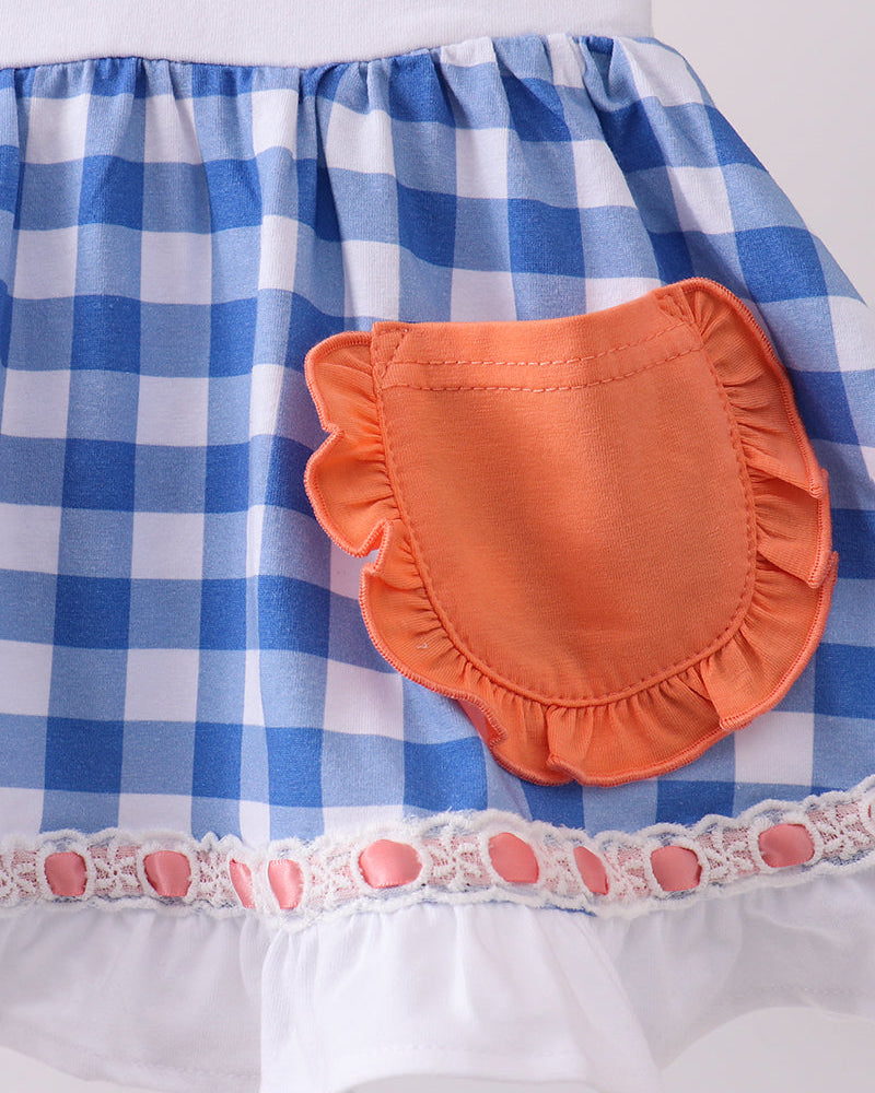 Blue and white checkered fabric with an orange pocket on a white background