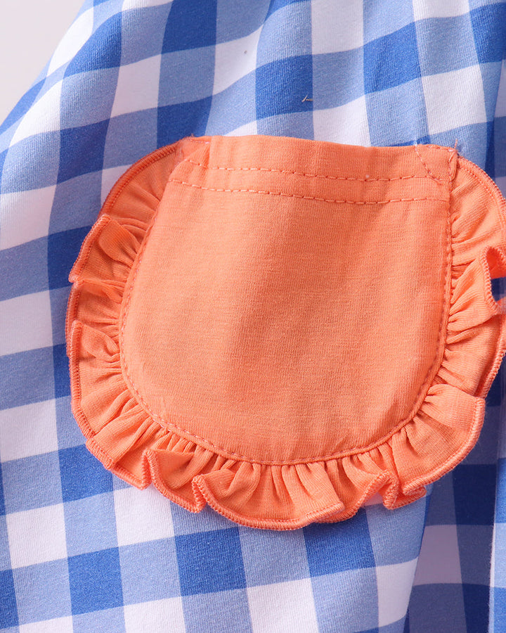 Close-up of an orange pocket on a blue and white checkered fabric