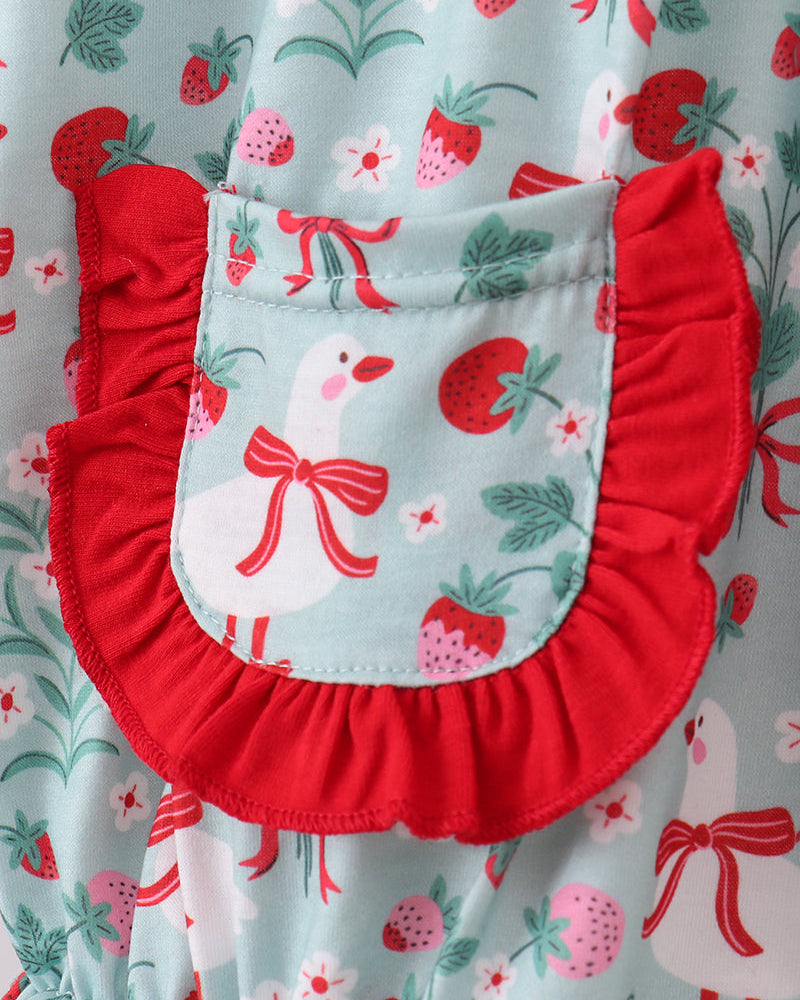 Red romper with a floral pattern on a matching fabric background
