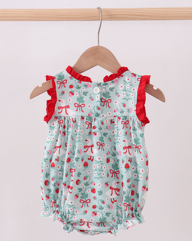 Baby romper with red bows and ruffles on a hanger against a white background