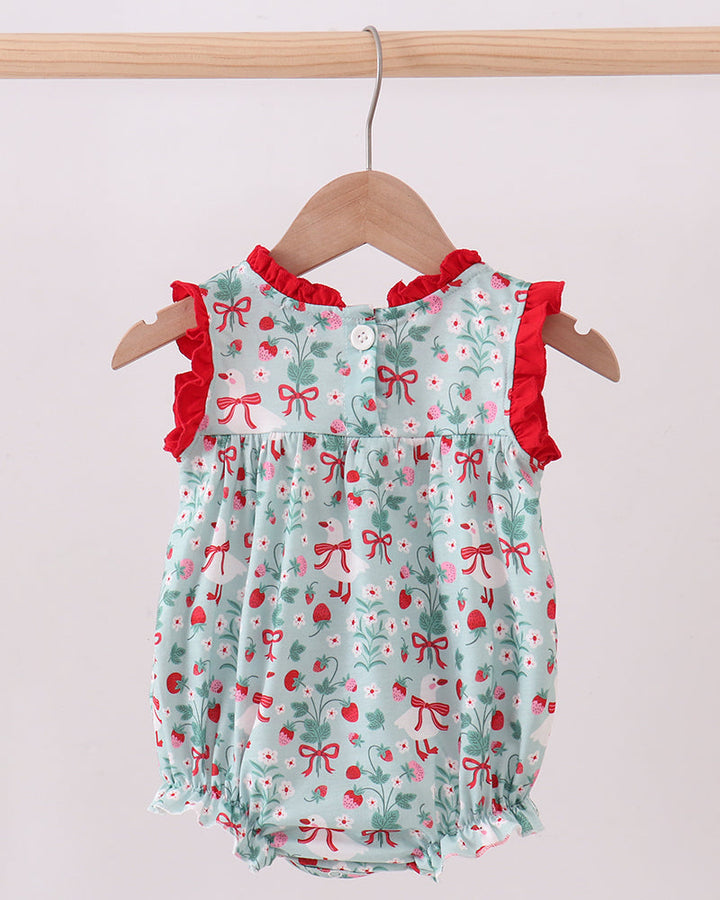 Baby romper with red bows and ruffles on a hanger against a white background