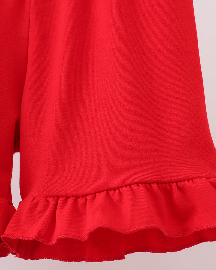 Red shorts with ruffled hem on a light background