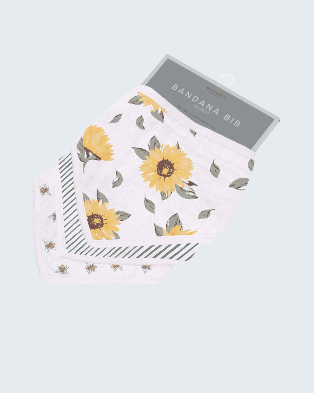 Floral patterned bandana bib with a gray label on a light blue background