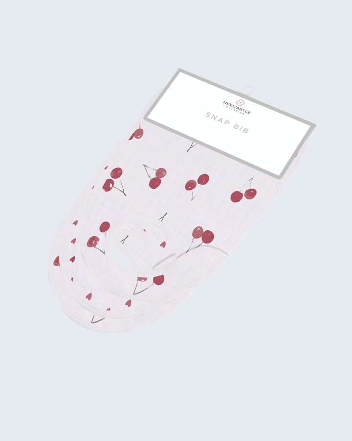 Baby bib with cherry pattern on a light gray background