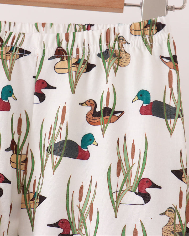 Tan pajama pants with allover duck and plant print, elastic waistband