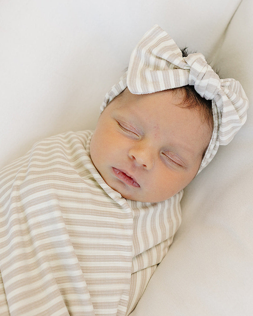 Striped head wrap with knotted bow worn on baby’s head