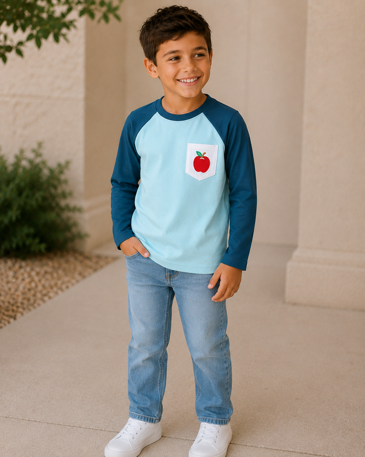 Young boy standing outside looking to the side