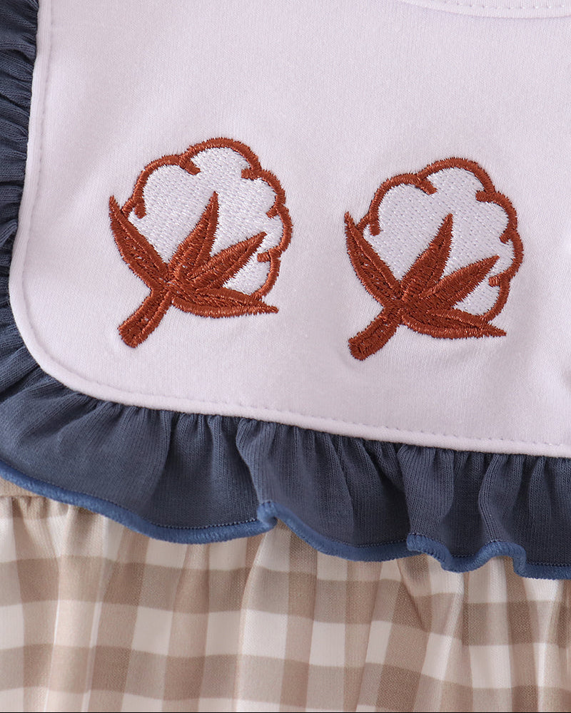 Teal gingham baby romper with embroidered leaf motifs and blue ruffle bib