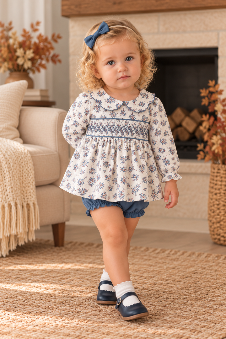 Toddler girl is wearing a Teal Floral Smocked Bloomer Set