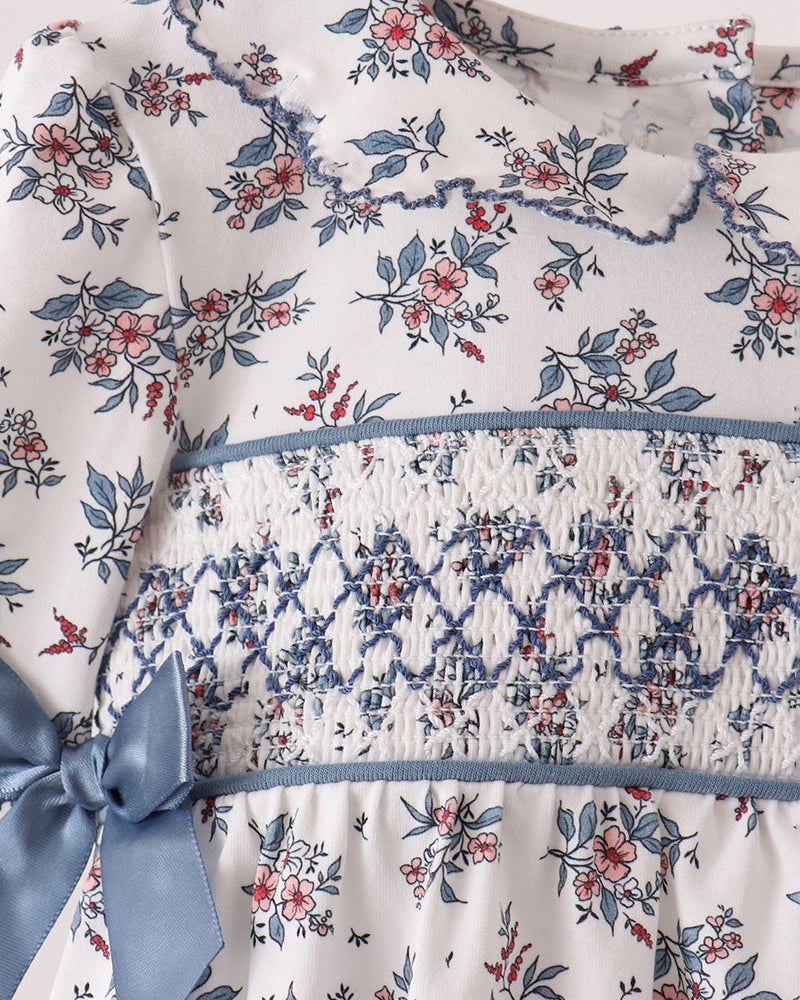 Floral smocked bodice bubble dress with blue ribbon bow and gathered waist