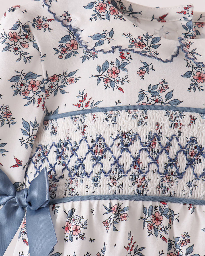 Floral smocked bodice bubble dress with blue ribbon bow and gathered waist