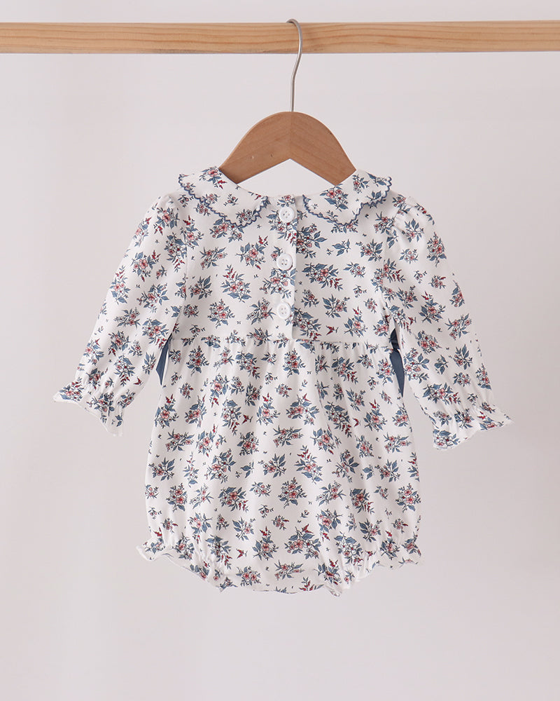 Floral smocked bubble dress with long sleeves and bow, white with blue and red flowers