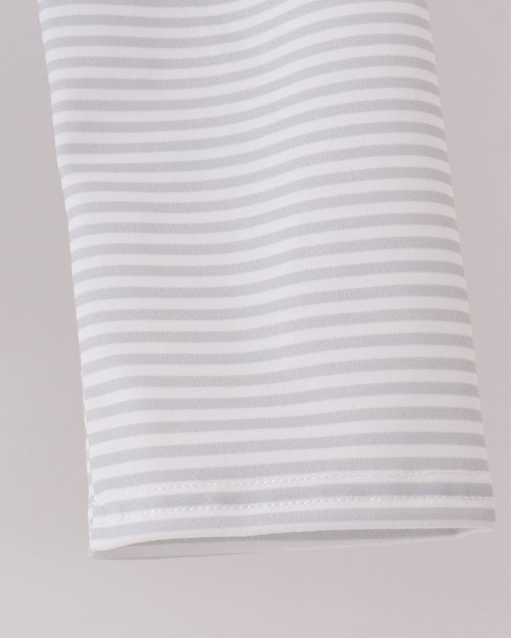 A close-up of a white fabric item, featuring thin, evenly spaced light gray horizontal stripes.