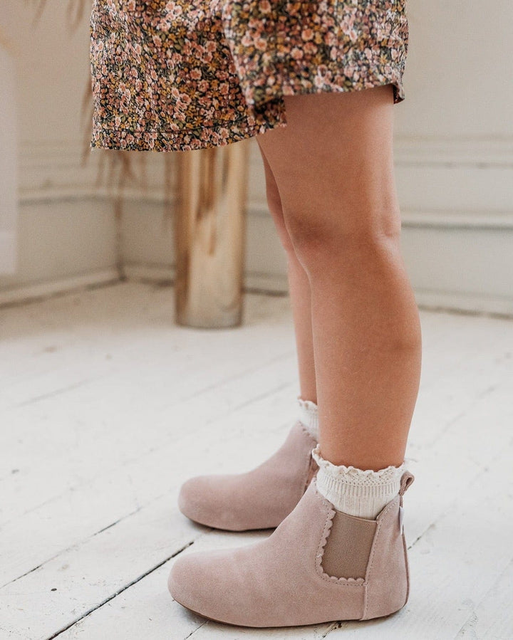 Light pink suede baby boots with elastic side panels and stitched toe seam