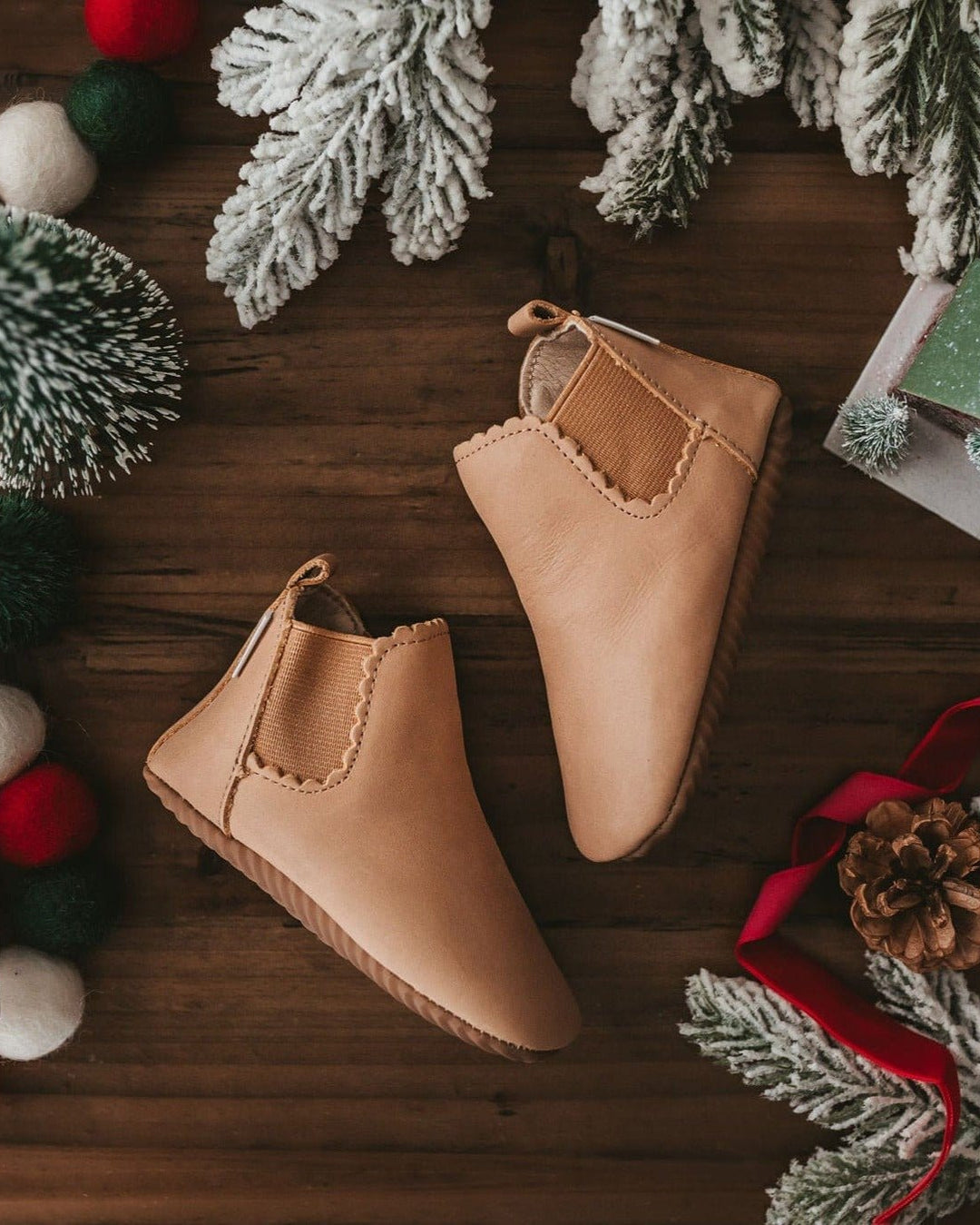 Tan suede baby boots with elastic side gore and scalloped ankle stitching