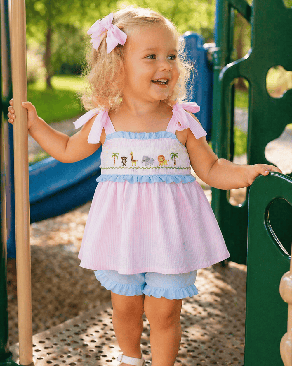 Child in a colorful dress with animal prints on a playground
