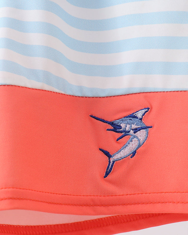 Close-up of a swimsuit with a shark design on a striped background