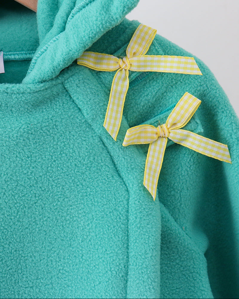 Turquoise fleece coat with yellow gingham bow detail at collar
