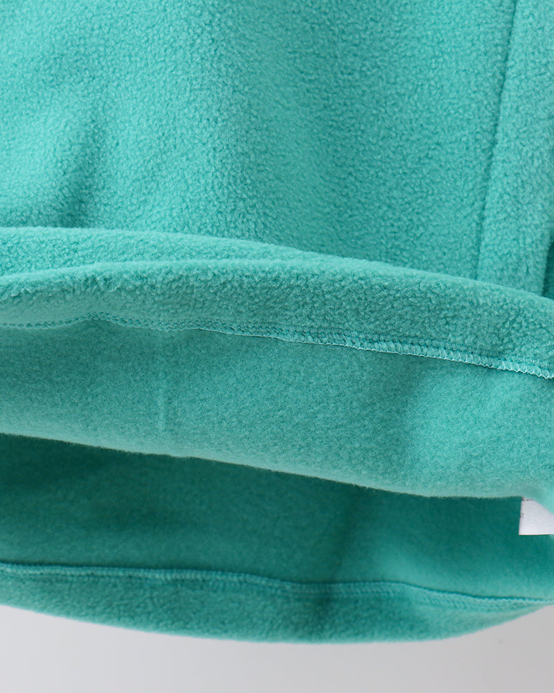 Turquoise fleece coat sleeve cuff and hem seam detail