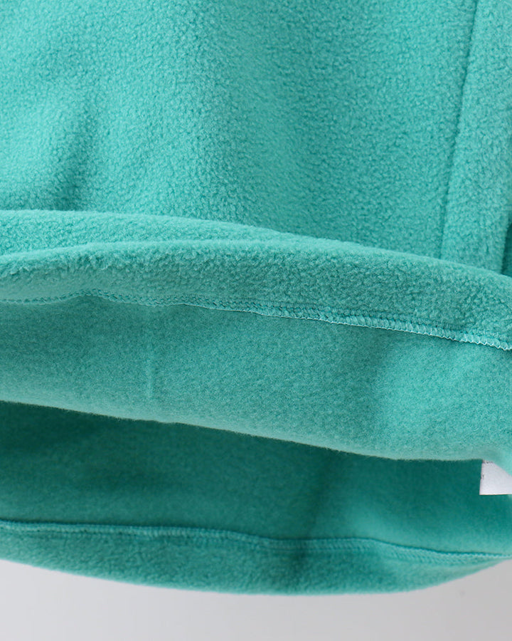 Turquoise fleece coat sleeve cuff and hem seam detail