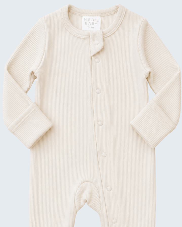 Cream ribbed snap-front baby one-piece with fold-over collar and front buttons