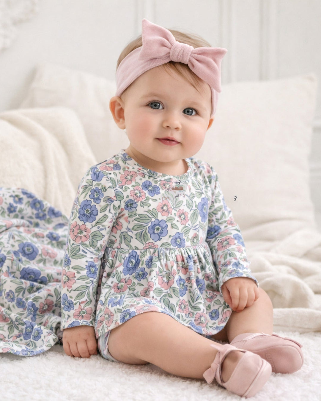 Floral long-sleeve baby bodysuit with gathered skirted peplum