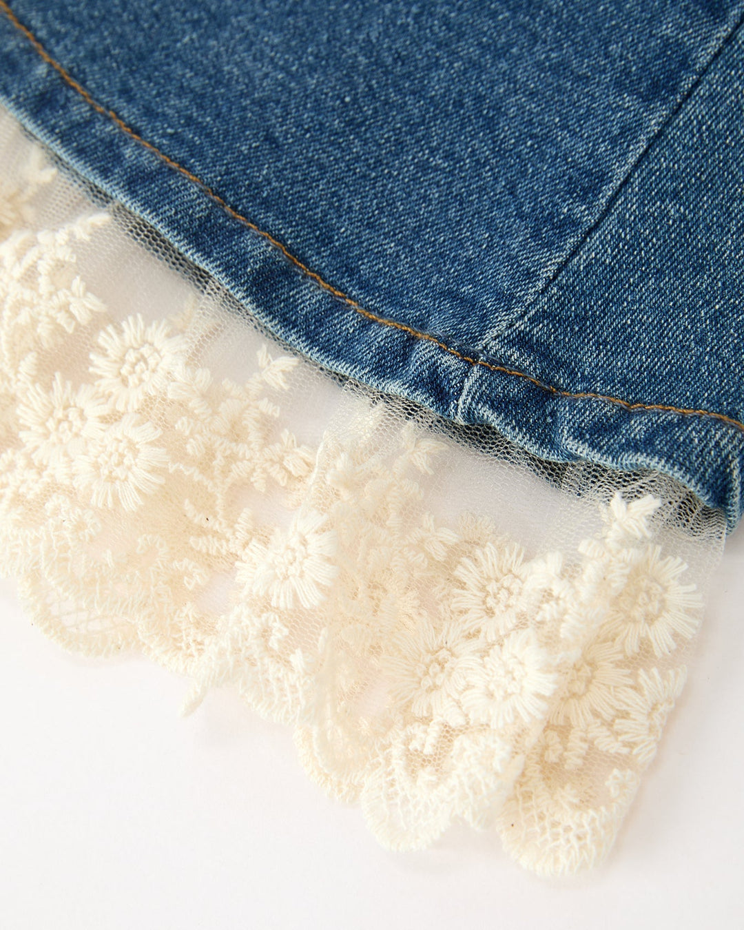 Blue denim bell-bottom with cream lace trim along the hem