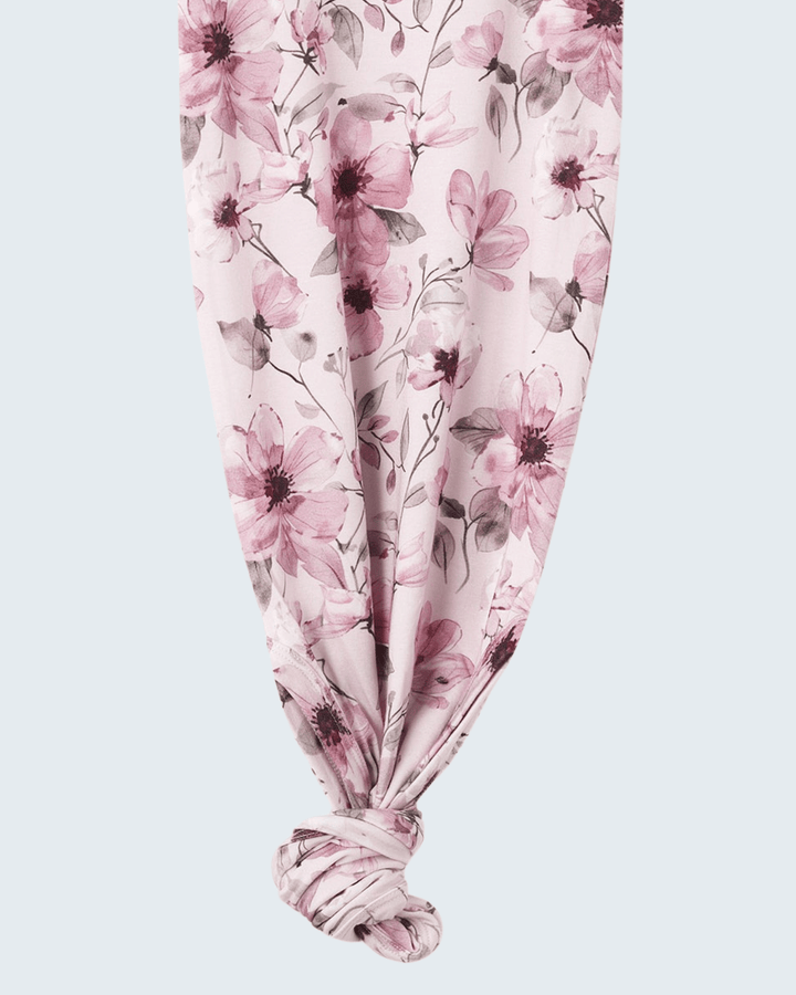 Pink watercolor floral knot gown with gathered knotted hem
