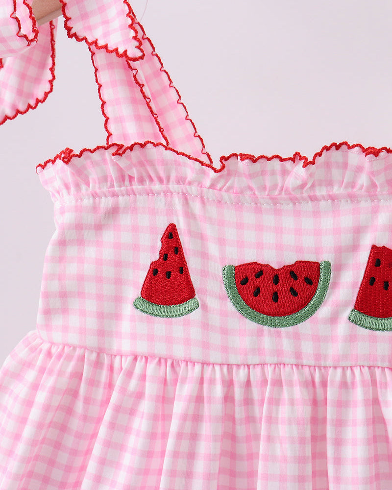 Pink checkered dress with watermelon designs on a white background