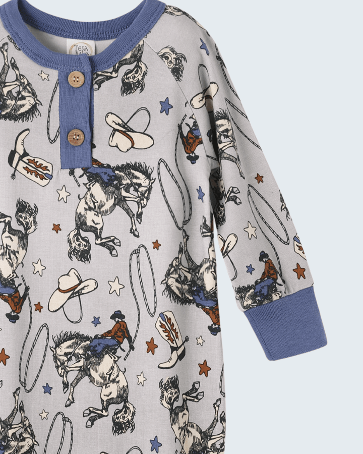 Cowboy print henley bamboo romper with two-button placket and navy long-sleeve cuffs
