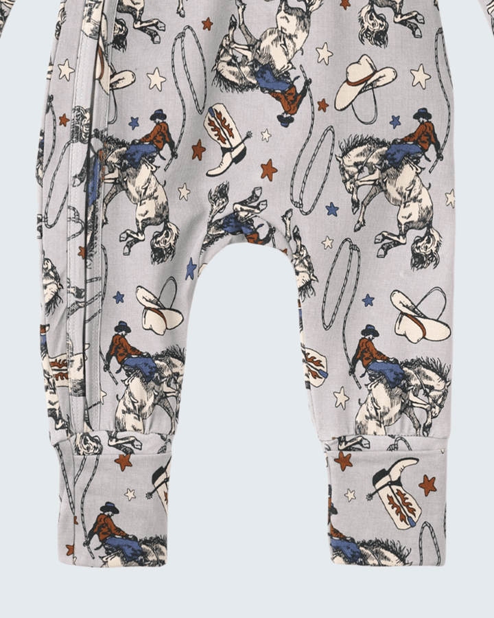 Light gray western romper legs with rodeo horses, cowboys, cowboy boots and star print