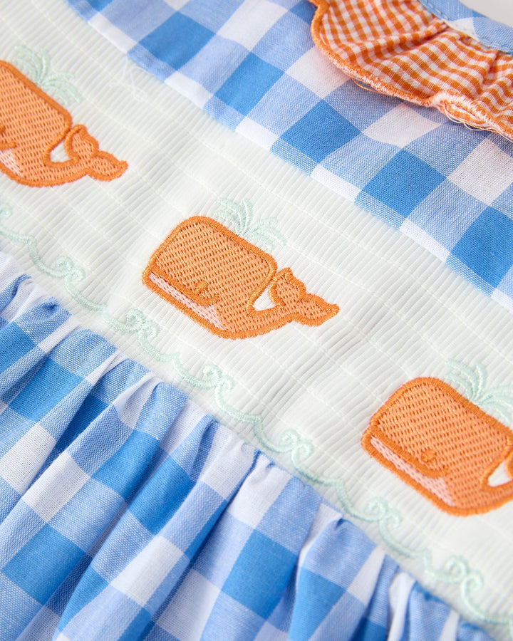 Close up of whale embroidered dress