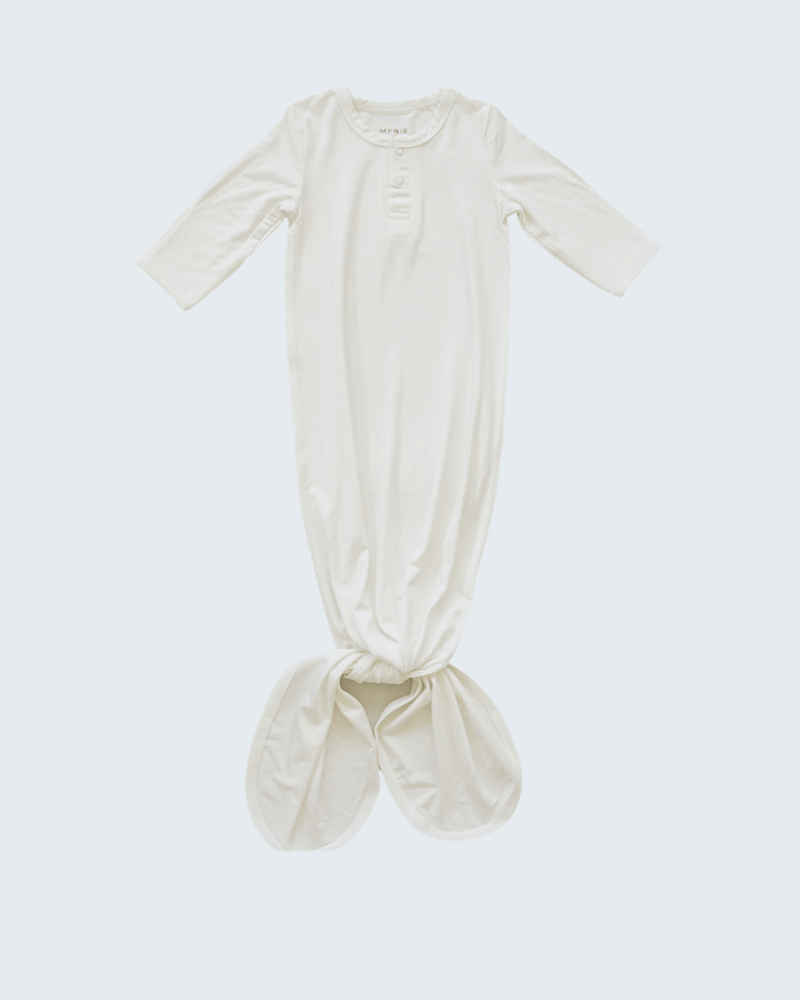 White baby gown on a light gray background