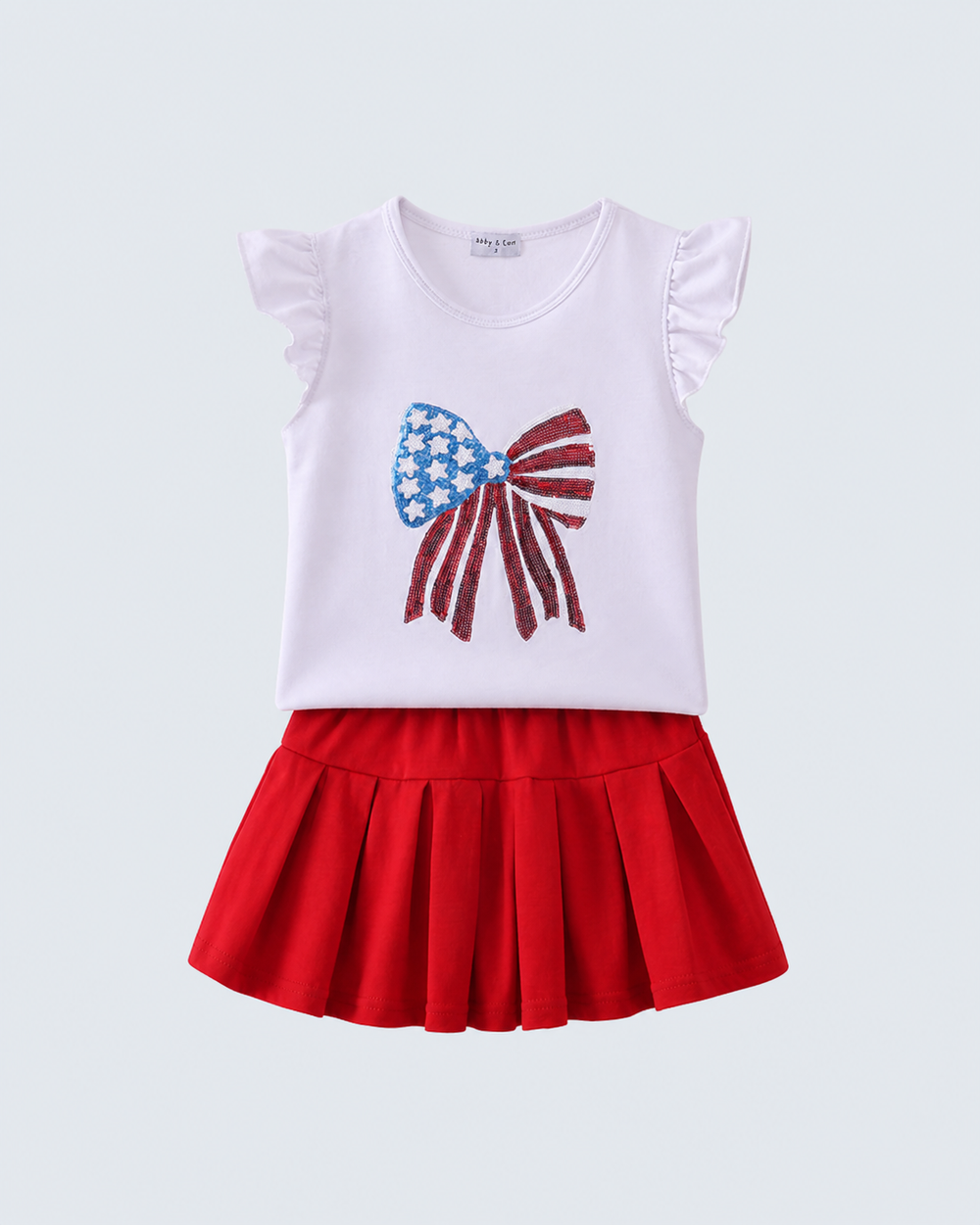 Girls sleeveless white bow print top and red pleated skirt set on a hanger