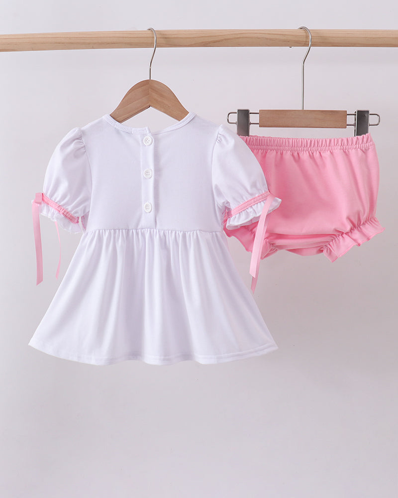 White button-front dress with pink ruffle sleeves and matching pink bloomer shorts