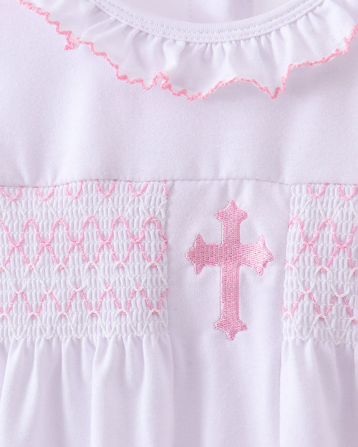 White top yoke with pink cross embroidery and smocked details